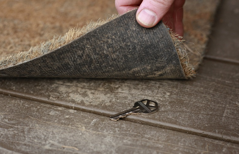 escape room puzzle: key hidden under a mat